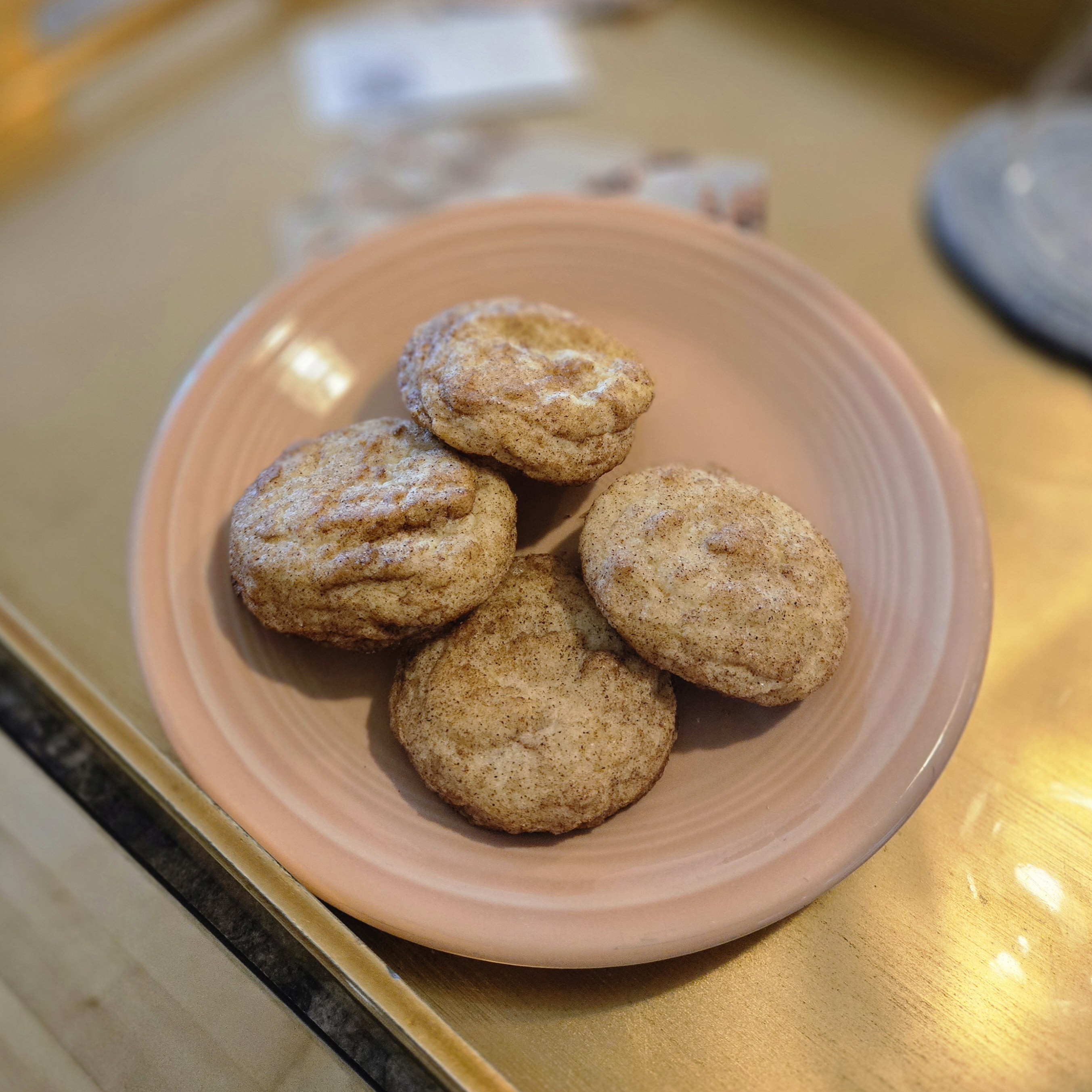 Snickerdoodle cookies on a pink plate.